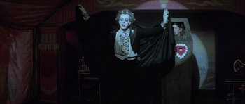Movie still from “The Funhouse” (1981), directed by Tobe Hooper – A man dressed as the joker in the dark; Medium shot, Low angle
