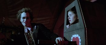 Movie still from “The Funhouse” (1981), directed by Tobe Hooper – A woman looking out of a window in a dark room; Medium shot, Low angle