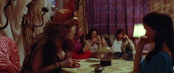 Movie still from “The Funhouse” (1981), directed by Tobe Hooper – A woman sitting at a table looking at a crystal ball; Medium shot, Over the shoulder angle