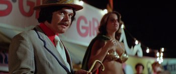 Movie still from “The Funhouse” (1981), directed by Tobe Hooper – A man and a woman dressed up in costumes; Medium shot, Low angle