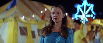 Movie still from “The Funhouse” (1981), directed by Tobe Hooper – A woman in a blue dress standing in front of lights; Close Up shot, Low angle