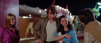 Movie still from “The Funhouse” (1981), directed by Tobe Hooper – A man and a woman standing next to each other; Medium shot, Over the shoulder angle