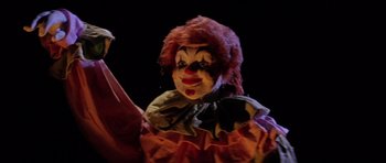 Movie still from “The Funhouse” (1981), directed by Tobe Hooper – A person wearing a clown mask; Close Up shot, Low angle