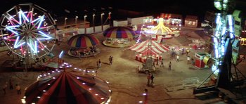 Movie still from “The Funhouse” (1981), directed by Tobe Hooper – An aerial view of a carnival at night; Extreme Wide shot, High angle