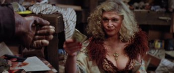 Movie still from “The Funhouse” (1981), directed by Tobe Hooper – An older woman is holding a piece of paper; Close Up shot, Over the shoulder angle