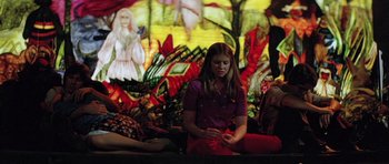 Movie still from “The Funhouse” (1981), directed by Tobe Hooper – A woman sitting in front of a stained - glass window; Medium shot, High angle