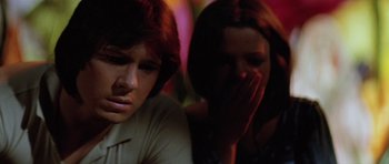 Movie still from “The Funhouse” (1981), directed by Tobe Hooper – A man and a woman sitting next to each other; Close Up shot, Low angle