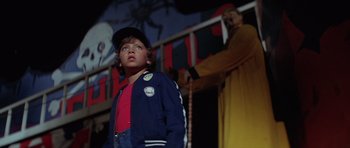 Movie still from “The Funhouse” (1981), directed by Tobe Hooper – A young boy wearing a baseball cap and jacket; Medium shot, Low angle