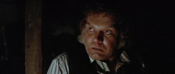 Movie still from “The Funhouse” (1981), directed by Tobe Hooper – An old man with a beard and a tie; Close Up shot, Low angle