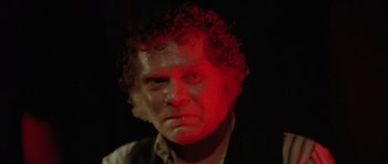 Movie still from “The Funhouse” (1981), directed by Tobe Hooper – A person with curly red hair; Close Up shot, Over the shoulder angle