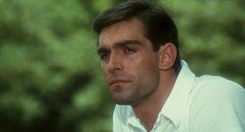 Movie still from “The Garden of the Finzi-Continis” (1970), directed by Vittorio De Sica – A person wearing a white shirt; Close Up shot, Low angle
