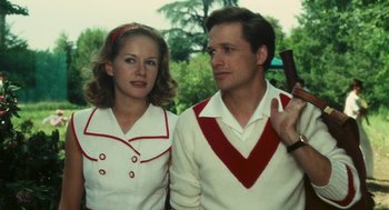 Movie still from “The Garden of the Finzi-Continis” (1970), directed by Vittorio De Sica – A man and a woman standing next to each other; Medium shot, Low angle