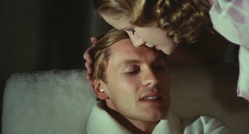 Movie still from “The Garden of the Finzi-Continis” (1970), directed by Vittorio De Sica – A man and a woman laying on a bed; Close Up shot, Over the shoulder angle