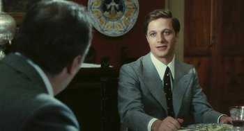 Movie still from “The Garden of the Finzi-Continis” (1970), directed by Vittorio De Sica – A man in a suit and tie sitting in front of another man in a suit; Medium shot, Over the shoulder angle