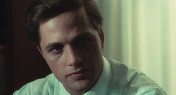 Movie still from “The Garden of the Finzi-Continis” (1970), directed by Vittorio De Sica – A person wearing a white dress shirt; Close Up shot, Over the shoulder angle