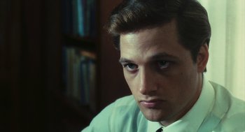 Movie still from “The Garden of the Finzi-Continis” (1970), directed by Vittorio De Sica – A young man in a white dress shirt and a tie; Close Up shot, Over the shoulder angle