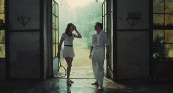 Movie still from “The Garden of the Finzi-Continis” (1970), directed by Vittorio De Sica – A man and a woman holding tennis rackets; Medium shot, Low angle