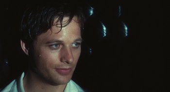 Movie still from “The Garden of the Finzi-Continis” (1970), directed by Vittorio De Sica – A person wearing a white shirt; Close Up shot, Over the shoulder angle