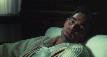 Movie still from “The Garden of the Finzi-Continis” (1970), directed by Vittorio De Sica – A person laying on a couch; Close Up shot, High angle