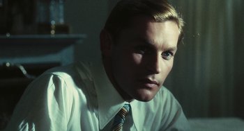 Movie still from “The Garden of the Finzi-Continis” (1970), directed by Vittorio De Sica – A person wearing a shirt and tie; Close Up shot, Over the shoulder angle