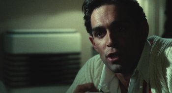 Movie still from “The Garden of the Finzi-Continis” (1970), directed by Vittorio De Sica – A person wearing a white shirt; Close Up shot, Over the shoulder angle