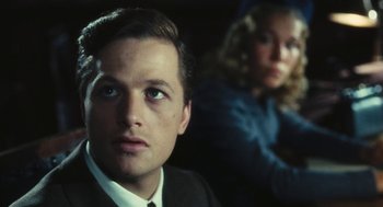 Movie still from “The Garden of the Finzi-Continis” (1970), directed by Vittorio De Sica – A man and a woman are looking at the camera; Close Up shot, Over the shoulder angle