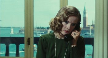 Movie still from “The Garden of the Finzi-Continis” (1970), directed by Vittorio De Sica – A woman talking on a phone while wearing a green blouse; Close Up shot, Over the shoulder angle