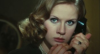 Movie still from “The Garden of the Finzi-Continis” (1970), directed by Vittorio De Sica – A beautiful woman with blue eyes holding her hand to her face; Close Up shot, High angle