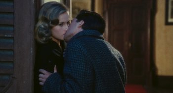 Movie still from “The Garden of the Finzi-Continis” (1970), directed by Vittorio De Sica – A man and a woman kissing on the lips; Close Up shot, Over the shoulder angle