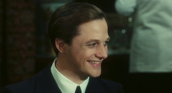 Movie still from “The Garden of the Finzi-Continis” (1970), directed by Vittorio De Sica – A person wearing a suit and tie; Close Up shot, High angle