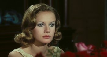Movie still from “The Garden of the Finzi-Continis” (1970), directed by Vittorio De Sica – A beautiful woman with long blonde hair wearing a white dress; Close Up shot, Over the shoulder angle