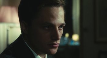 Movie still from “The Garden of the Finzi-Continis” (1970), directed by Vittorio De Sica – A person wearing a suit and tie; Close Up shot, Low angle