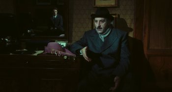 Movie still from “The Garden of the Finzi-Continis” (1970), directed by Vittorio De Sica – An old man sitting in a chair in front of a mirror; Medium shot, Over the shoulder angle