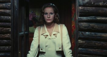 Movie still from “The Garden of the Finzi-Continis” (1970), directed by Vittorio De Sica – A woman wearing a white dress and a jacket; Medium shot, Low angle