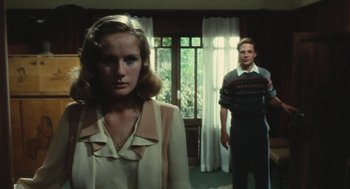 Movie still from “The Garden of the Finzi-Continis” (1970), directed by Vittorio De Sica – A man and a woman standing in front of a window; Medium shot, Over the shoulder angle