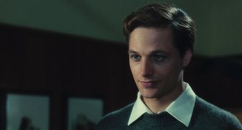 Movie still from “The Garden of the Finzi-Continis” (1970), directed by Vittorio De Sica – A young man with short brown hair wearing a sweater; Close Up shot, Over the shoulder angle