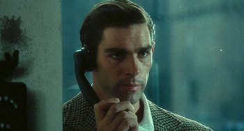 Movie still from “The Garden of the Finzi-Continis” (1970), directed by Vittorio De Sica – A person holding a phone up to their ear; Close Up shot, Over the shoulder angle