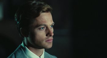 Movie still from “The Garden of the Finzi-Continis” (1970), directed by Vittorio De Sica – A person wearing a suit and tie; Close Up shot, Over the shoulder angle