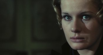 Movie still from “The Garden of the Finzi-Continis” (1970), directed by Vittorio De Sica – A woman's face in a dark room; Close Up shot, Over the shoulder angle