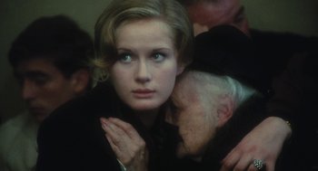 Movie still from “The Garden of the Finzi-Continis” (1970), directed by Vittorio De Sica – A woman with her hands clasped around her neck; Close Up shot, Over the shoulder angle