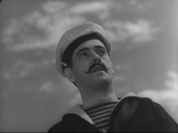 Movie still from “The Gay Divorcee” (1934), directed by Mark Sandrich – A man with a mustache wearing a sailor's hat; Close Up shot, Low angle