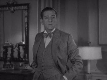 Movie still from “The Gay Divorcee” (1934), directed by Mark Sandrich – A black and white photo of a man in a suit; Medium shot, Low angle