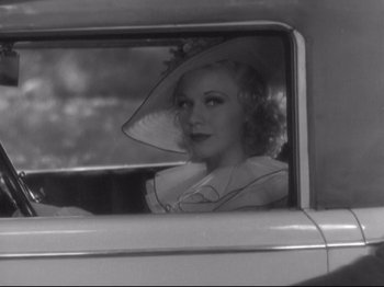 Movie still from “The Gay Divorcee” (1934), directed by Mark Sandrich – A black and white photo of a woman in a car; Close Up shot, Over the shoulder angle