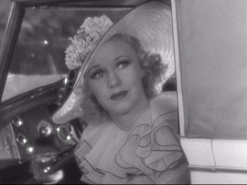 Movie still from “The Gay Divorcee” (1934), directed by Mark Sandrich – An old photo of a woman with a hat in a car; Close Up shot, High angle