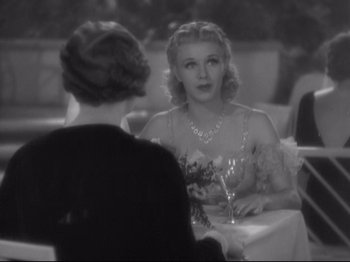 Movie still from “The Gay Divorcee” (1934), directed by Mark Sandrich – Two women sitting at a table with a glass of wine; Medium shot, Over the shoulder angle
