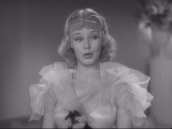 Movie still from “The Gay Divorcee” (1934), directed by Mark Sandrich – A black - and - white photo of a woman holding a star; Close Up shot, Low angle