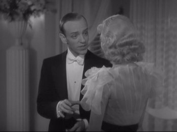 Movie still from “The Gay Divorcee” (1934), directed by Mark Sandrich – A man and a woman are talking to each other; Medium shot, Over the shoulder angle