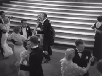 Movie still from “The Gay Divorcee” (1934), directed by Mark Sandrich – A black and white photo of people in formal wear dancing; Wide shot, High angle