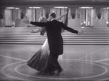 Movie still from “The Gay Divorcee” (1934), directed by Mark Sandrich – A man and a woman dancing in a ballroom; Wide shot, Low angle