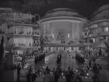 Movie still from “The Gay Divorcee” (1934), directed by Mark Sandrich – A black - and - white photo of people in an auditorium; Extreme Wide shot, High angle